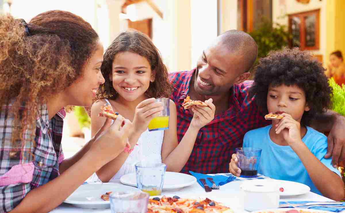 Family eating to talk about the fact that SNAP can give a four-member family up to $973